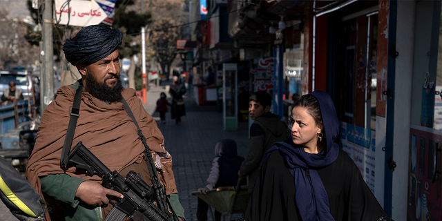 Taliban fighter and Afghan woman