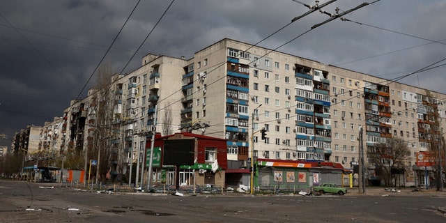 Ukrainian apartment building destroyed after military strike, clodu skies