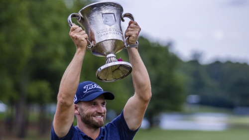 Wyndham Clark raises the Wells Fargo Championship Trophy after winning at Quail Hollow Club in Charlotte, North Carolina.