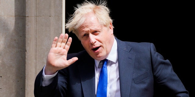 UK Prime Minister Boris Johnson waves to reporters July 6, 2022 in London