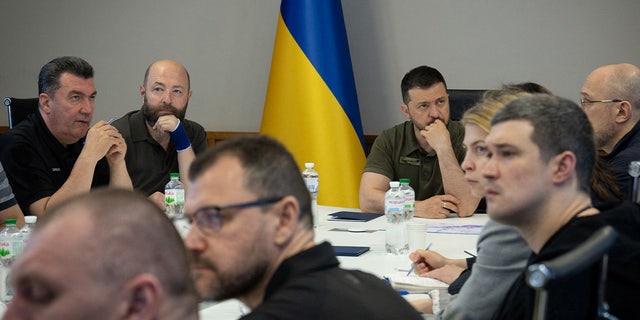 Zelenskyy at conference table with other officials