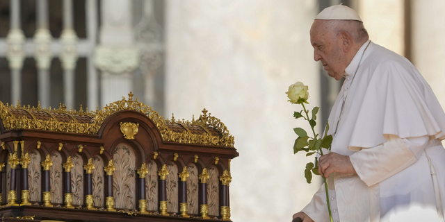 Pope Francis prays in front of relics at Vatican