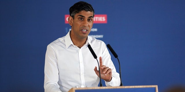 Rishi Sunak in front of stop the boats podium