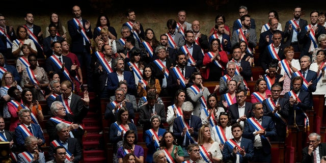 Lawmakers in France's National Assembly pay tribute to knife attack victims