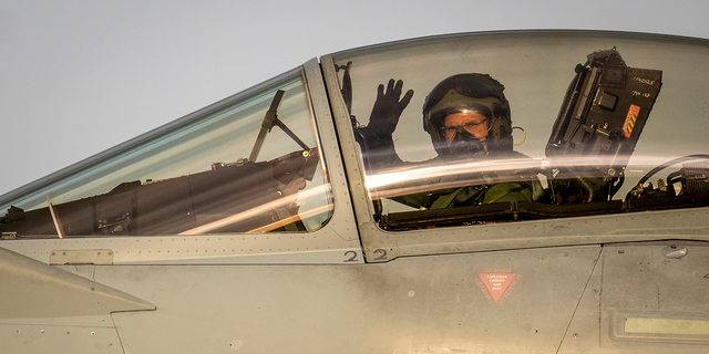 Airman waving in an aircraft