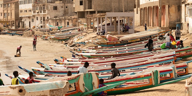 Children play on fishing boats