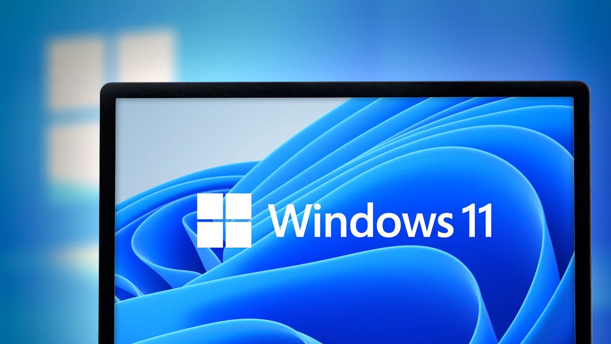 Windows 11 logo on a wavy blue background on a laptop screen