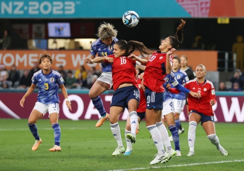 Japan's Mina Tanaka heads the ball toward the Costa Rican goal.