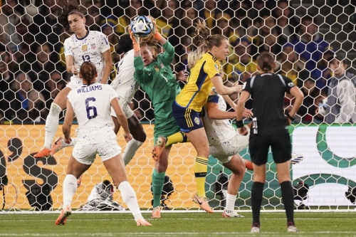United States' goalkeeper Alyssa Naeher, center, takes the ball in front of the goal.