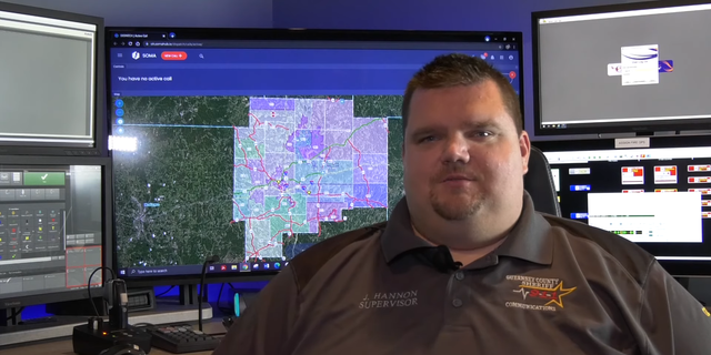 Ohio 911 dispatcher in front of monitor
