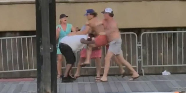 People brawling on the dock