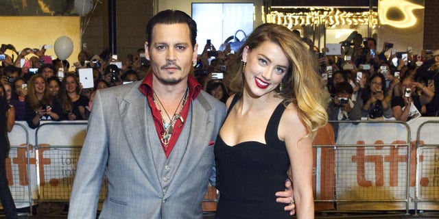 Johnny Depp smile while on red carpet in London for premiere