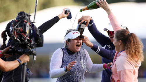 Lilia Vu of the United States celebrates as drinks are poured on her on the 18th green on Day Four of the AIG Women's Open at Walton Heath Golf Club on August 13, 2023 in Tadworth, England.