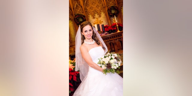 Bride holds floral bouquet in church