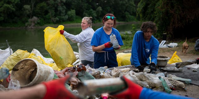 1.	Volunteers in Hungary sort collected litter 