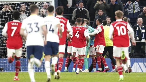 Arsenal goalkeeper Aaron Ramsdale (centre) is held back by team-mates after a fan attempts to hit the player after the final whistle in the Premier League match at the Tottenham Hotspur Stadium, London. Picture date: Sunday January 15, 2023. (Press Association via AP Images)