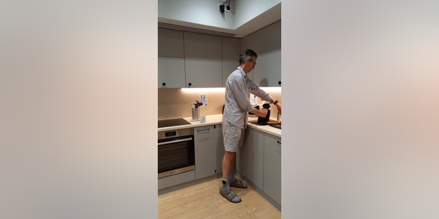 man models SmartSocks while standing in kitchen