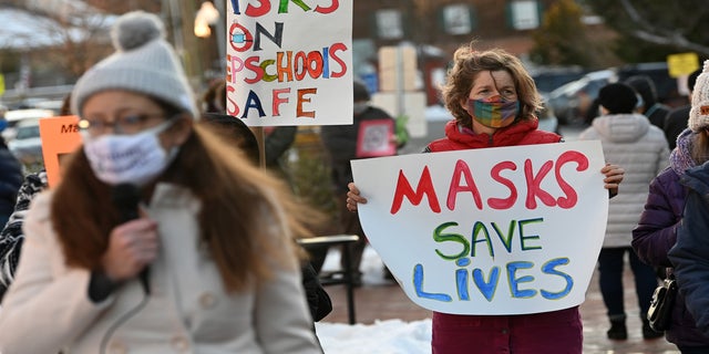 People gather in support of continuing the school mask mandate