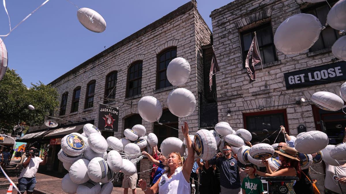 People release balloons in memory of Doug Kantor in downtown Austin