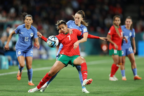 Morocco's Ghizlane Chebbak and France's Sandie Toletti compete for the ball. 