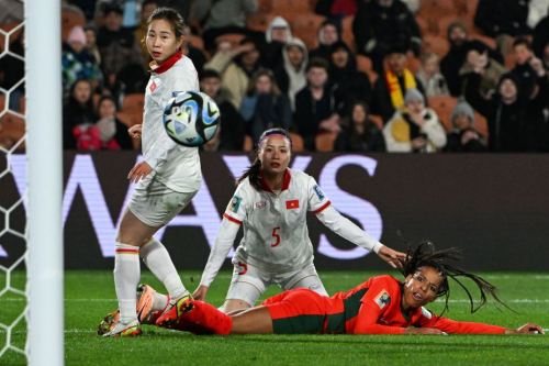 Portugal forward Jéssica Silva, right, watches a shot go wide during a match against Vietnam on July 27. Portugal won 2-0, eliminating Vietnam's hopes of advancing in the tournament.