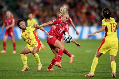 China's Zhang Linyan competes for the ball with Denmark's Pernille Harder.