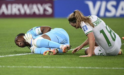 Nigeria's Chiamaka Nnadozie and Ireland's Kyra Carusa react after a collision.