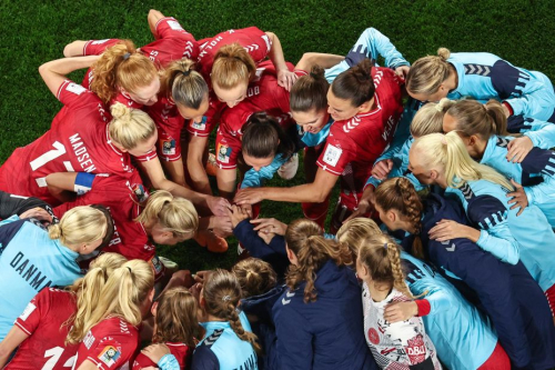 Denmark's players gather in a huddle before the match against Australia.
