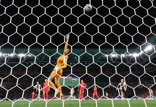 South Korean goalkeeper Kim Jung-mi dives for the ball during the match against Germany.