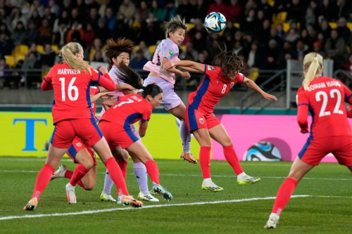Japan's Mina Tanaka, center, rises for a header against Norway.