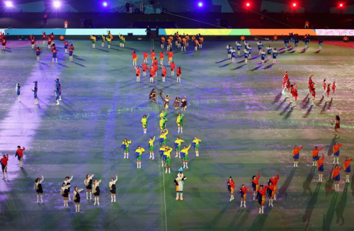 Dancers take the field during the opening ceremony.