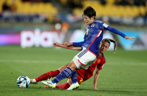 Japan's Hikaru Naomoto, top, and Spain's Ona Batlle compete for the ball.