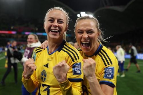 Amanda Ilestedt and Fridolina Rolfo of Sweden celebrate their team's victory through the penalty shootout eliminating defending champion Team USA.