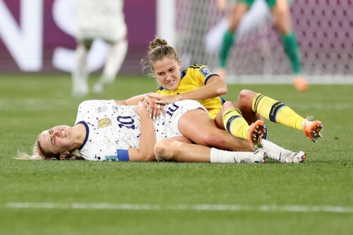 Lindsey Horan of the United States grimaces in pain after a collision.