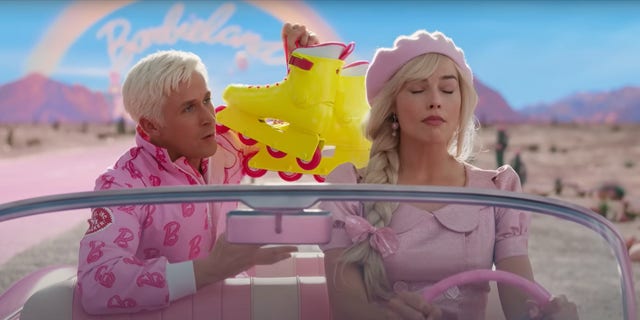 Ryan Gosling as Ken and Margot Robbie as Barbie driving pink car