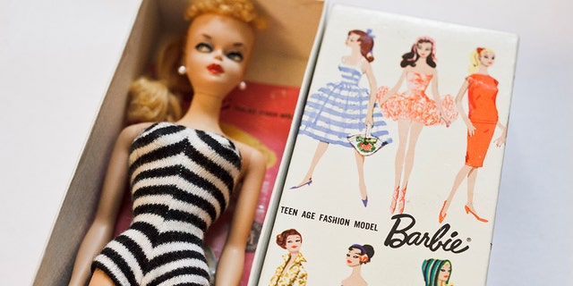 Barbie doll pictured wearing striped swimsuit
