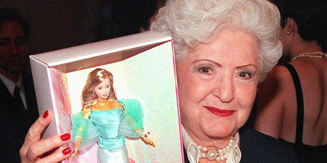 Ruth Handler holds a Barbie doll box at press conference
