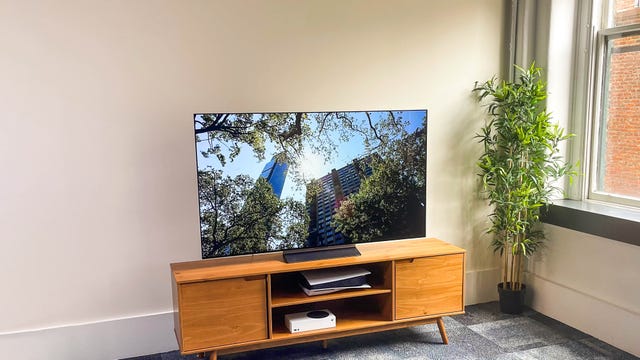 LG C OLED TV on a wood cabinet.