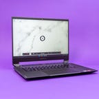 Corsair Voyager a1600 gaming laptop open on a purple background.
