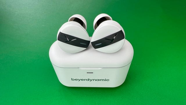 The white Beyerdynamic Free Byrd earbuds and their charging case