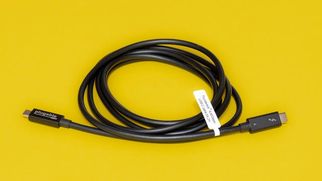 A coiled Plugable Active 2M USB-C cable with a white specifications label