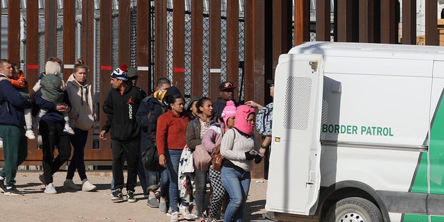 Migrants entering a van