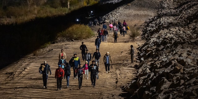 Immigrants at border crossing at night