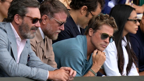 Actor Brad Pitt and director Guy Ritchie sit in the stands on Centre Court for the final of the men's singles between Spain's Carlos Alcaraz and Serbia's Novak Djokovic on day fourteen of the Wimbledon tennis championships in London, Sunday, July 16, 2023.