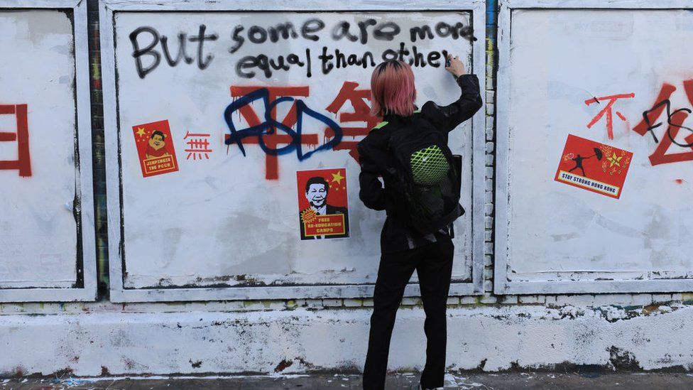 Pro-democracy activists and graffiti artists write over the Chinese slogans featuring Chinese Communist Party's core ideology on Bricklane, on August 06, 2023 in London, England.