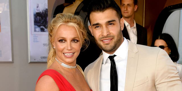 Britney Spears and Sam Asghari smiling at an event