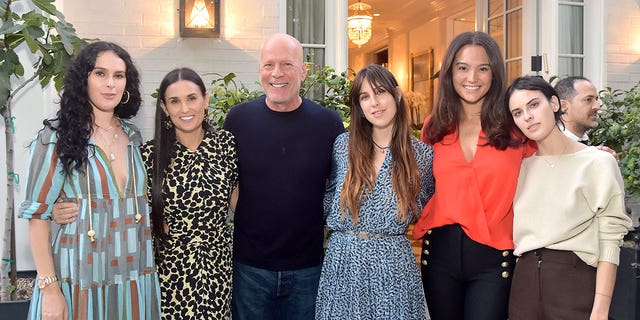 Bruce Willis hugs his daughters and wife Emma Herning at Demi Moores book launch