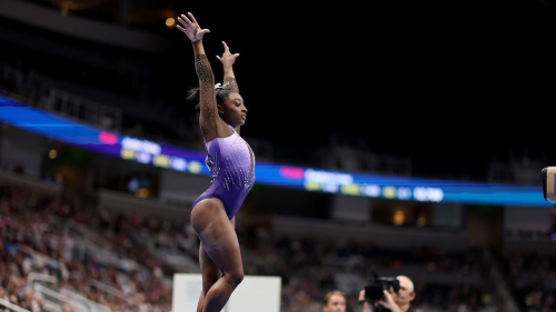 Biles leads the competition with four routines left to complete on Sunday.