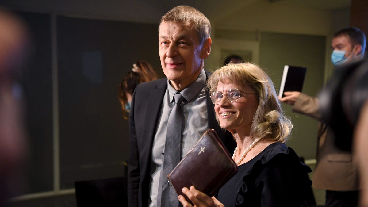 MP of the Finland's Christian Democrats Paivi Rasanen (R) holds a bible as she arrives with her husband Niilo Rasanen to attend a court session at the Helsinki District Court in Helsinki, Finland on January 24, 2022. - The trial against former interior minister and Christian Democrats leader Paivi Rasanen over four charges of incitement against a minority group has started on January 24, 2022. - Finland OUT (Photo by Antti Aimo-Koivisto / Lehtikuva / AFP) / Finland OUT (Photo by ANTTI AIMO-KOIVISTO/Lehtikuva/AFP via Getty Images)