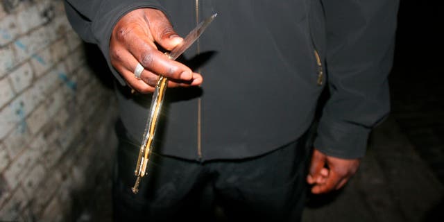 close-up on man holding butterfly knife in hand